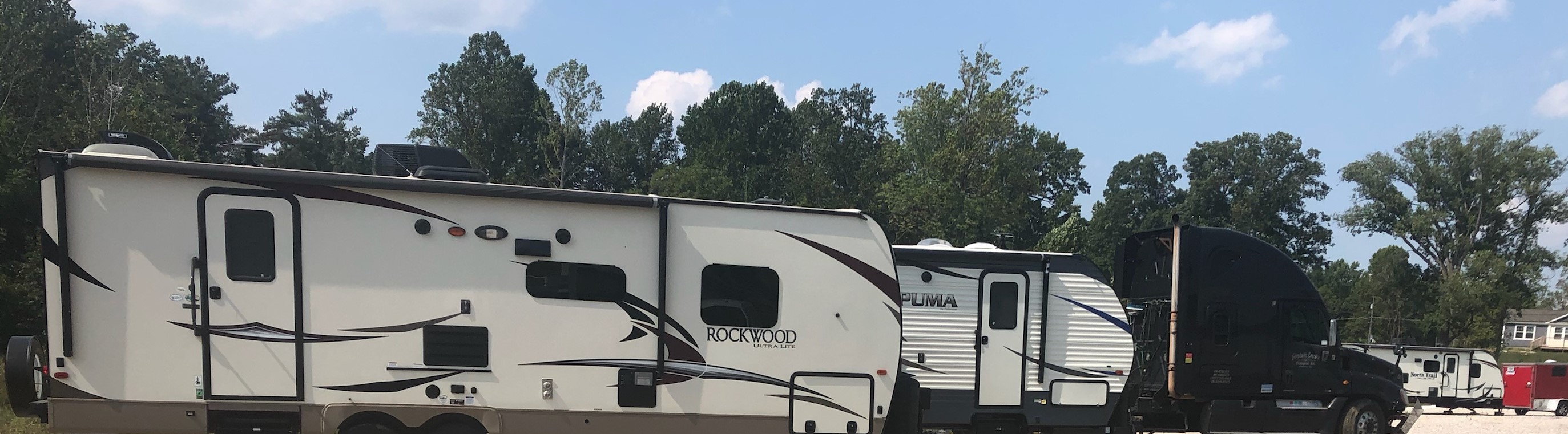 Spacious boat and RV parking area at Corydon Access Storage, offering secure and convenient outdoor storage options.